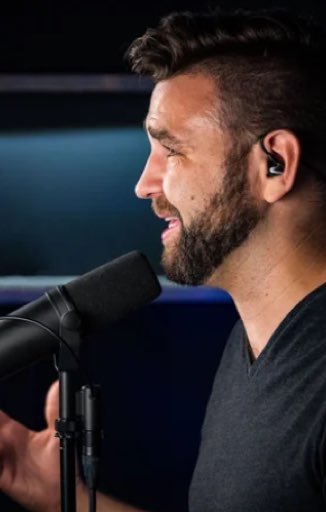Pastor Mark Lutz of Lux Digital Church speaking into a studio microphone